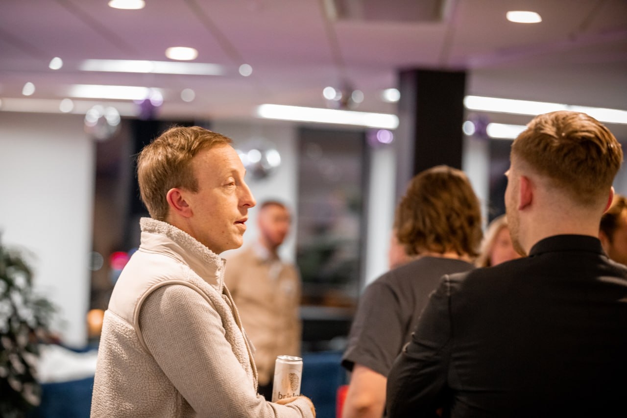 Mingel på QTE-event med deltagare som pratar i en lounge.